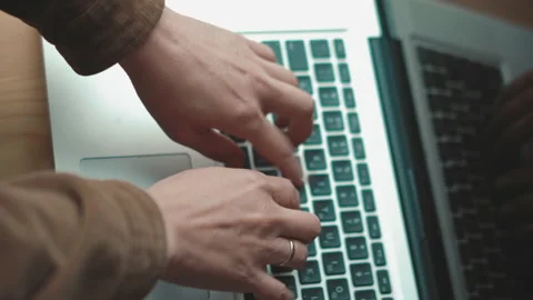 Top angle view.Woman hands typing on laptop keyboard sitting at windowsill Video stock 134425448