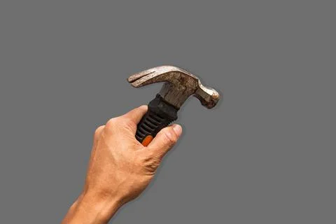 Top angle of a young man holding hammer on grey background Stock Photos