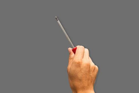 Top angle of a young man holding screwdriver philip on grey background Stock Photos