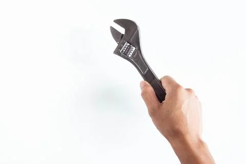 Top angle of young man right handed, holding adjustable wrench on white backg Stock Photos