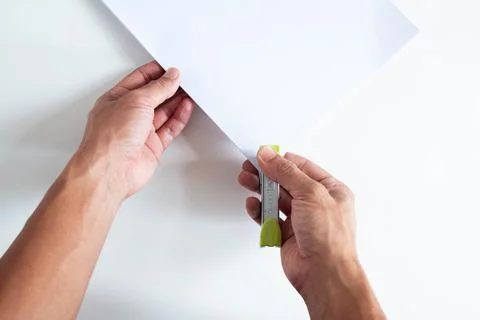 Top angle of young man right handed using green stapler on white background Stock Photos