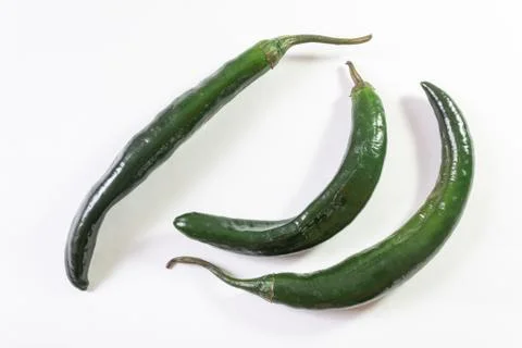 Top angled view of three green chilaca peppers isolated on white Stock Photos