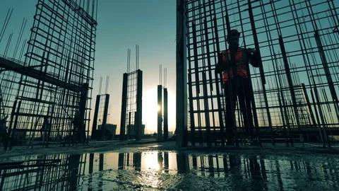 Top of a building at sunset with builders constructing carcasses Stock Footage 133766877