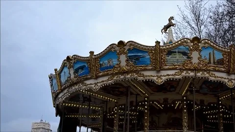 Top of a Carousel Spinning on a City Square Park Stock Footage 77952129