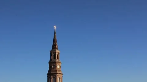 Top of cathedral sitting high in bright blue sky Stock Footage 45561397