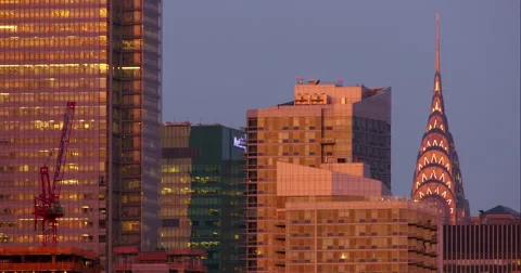 Top of Chrysler Building peaking out behind other New York City skyscrapers Stock Footage 67296443