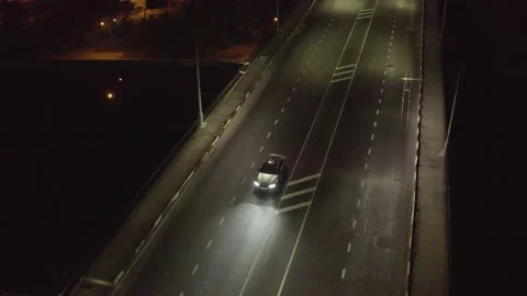Top cinematic aerial view to the sport car on the bridge at night. BMW M5 2022 Stock Footage 171456763