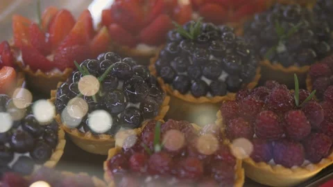 Top close up of fresh berry tartlets in bakery. Desserts and sweets concept. Stock Footage 141494058