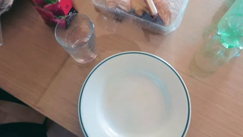 A top close up panning handy view of a breakfast dinning table having Stock Footage 121357663
