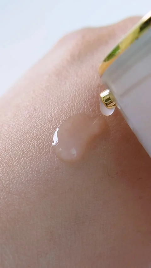 Top close up of pouring clear liquid onto hand skin. Beauty skincare concept Stock Footage 338279041
