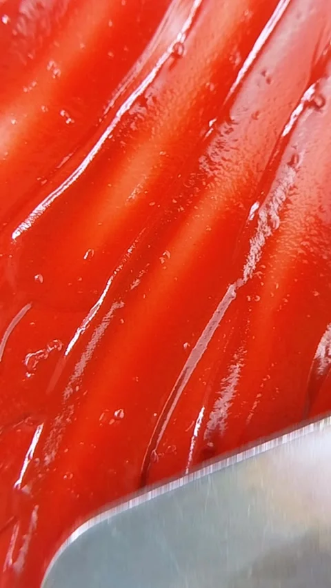 Top close up of spreading thick red liquid using a metal tool. Smooth coati.. Vídeo Stock 346933044