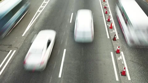 Top close-up timelapse view of many cars and trucks driving fast on the road Stock Footage 245183728
