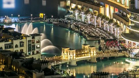 Top close up view of the bridge over man-made lake with music fountain show n Stock Photos
