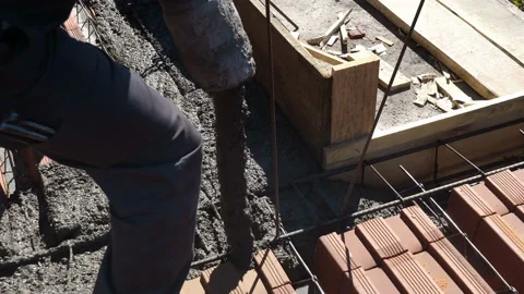 Top close up view of worker handling a massive cement or concrete pump on con Stock Footage 138906136