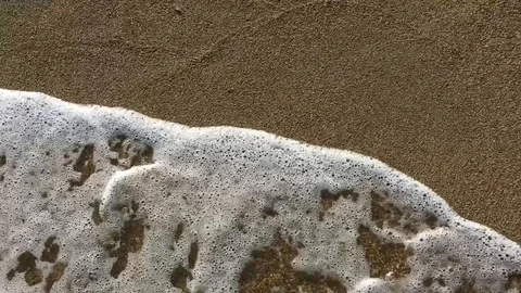 Top closeup view of the clear sea waves washing the sand on the coast in Greece Stock Footage 106095977
