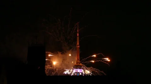 Top of CN Tower seen during fireworks show with old building in foreground Stock Footage 77810059