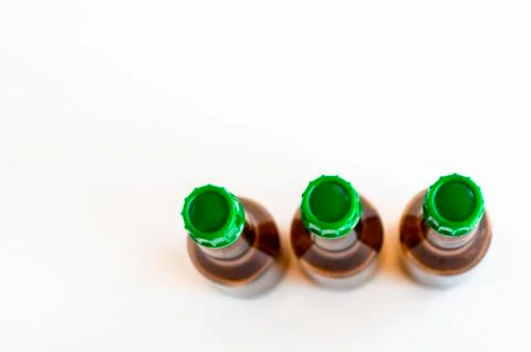 Top corner shoot of three line positioned small alcohol bottles brown colored Stock Photos