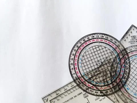 Top corner view of some navigation protractor shapes on a white background. Fotos de archivo