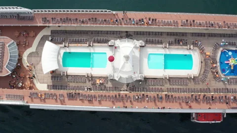 Top deck of a cruise ship with swimming pool and playground for kids - aerial Stock Footage 231601034