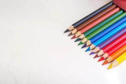 Top diagonal view of box with colored pencils on the white table Stockfoto's