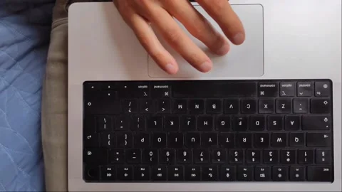 Top-Down 4K Shot of Hand Using Laptop Trackpad and Keyboard Video stock 334629137