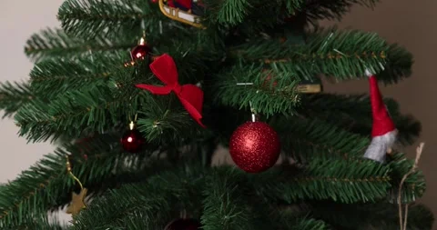 Top down 4K slowmotion footage of a hand decorating a beautiful Christmas tree Stock Footage 297954484