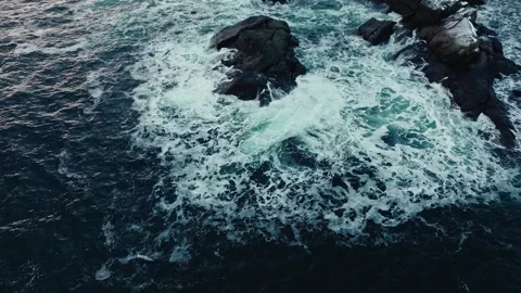 Top down abstract aerial view of ocean waves crashing on rocky shoreline Stock Footage 280235102