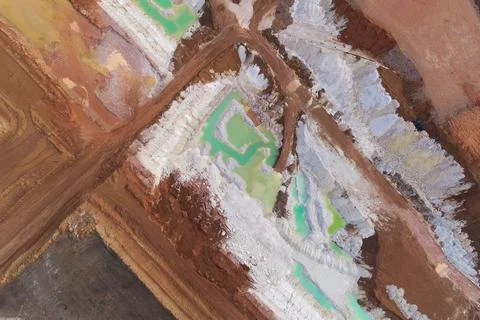 Top-down abstract aerial view of interconnected pools of toxic mint-green water Stock Photos