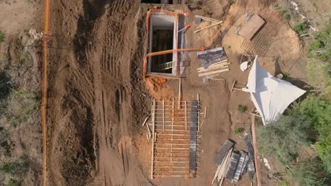 Top down aerial above construction site with workers and excavator digger Stock Footage 131007285