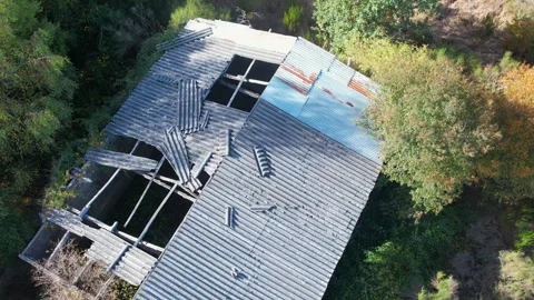 A top down aerial arc shot of a ruined building in nature The Concept of Deca 스톡 동영상 318443548