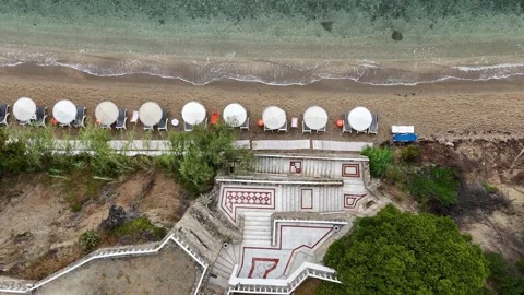Top Down Aerial Beach Umbrellas and Shoreline with Clear Sea Stock Footage 327730560