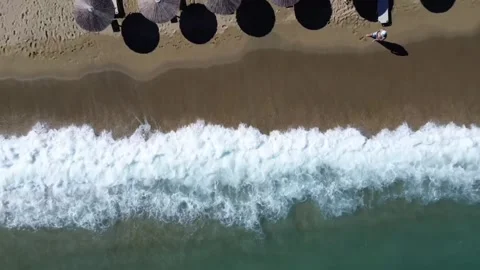 Top Down Aerial Beach Waves with Umbrellas and Person Video stock 332977324