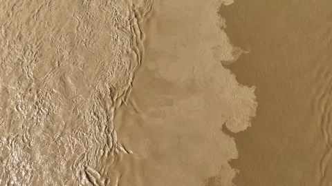 Top down aerial of brown river water currents and sediment mixing Stockbeeldmateriaal 332946111
