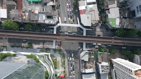 Top-down aerial of BTS Skytrain tracks and traffic in Bangkok, Thailand Stock Footage 315275839