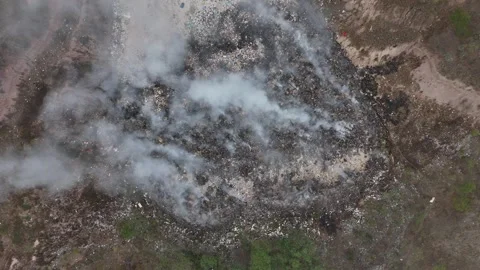 Top down aerial of burning trash pile and toxic smoke texture Stock Footage 340921441