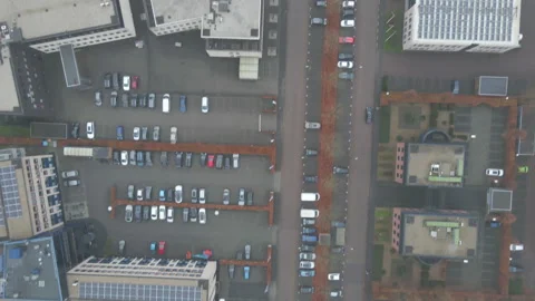 Top down aerial of car driving over busy industrial terrain Vídeo Stock 144495486