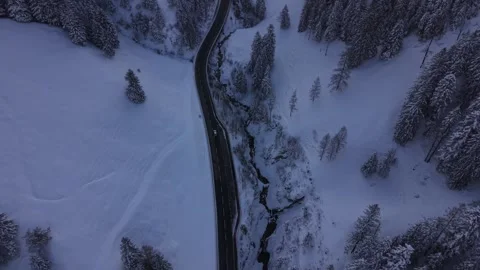 Top Down Aerial of Car Driving on Snowy Serpentine Mountain Road Stock-Footage 331644677