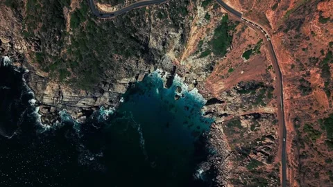 Top-down aerial of Chapman's Peak Drive above rocky cove Stock Footage 340556404