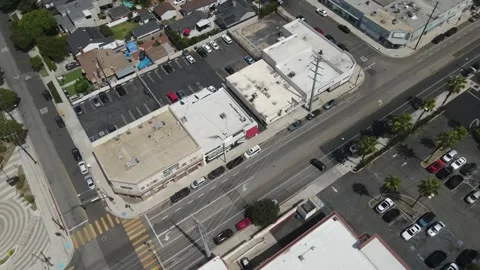 Top down aerial of a city intersection, rooftops and parking lots Stock Footage 345566564