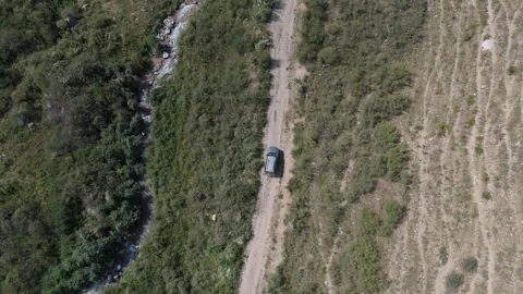 Top-down aerial close tracking shot of 4x4 driving on mountain track, Kyrgyzstan Video stock 347239973