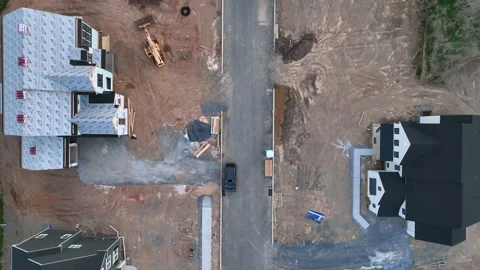 Top down aerial of construction site at new development. Descending drone Video stock 197129745