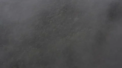Top-down aerial descending through misty cloud to reveal birds eye view of vast Stock-Footage 284249543