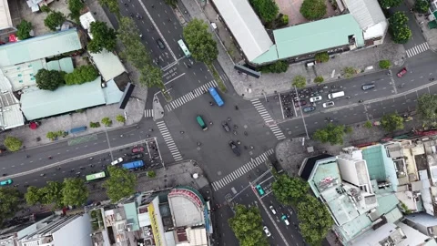 Top down aerial drifting across a Ho Chi Minh City crossroads Stock Footage 344332557