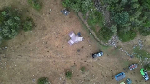 Top-down aerial drone ascent over tourist campsite Stock Footage 337407204