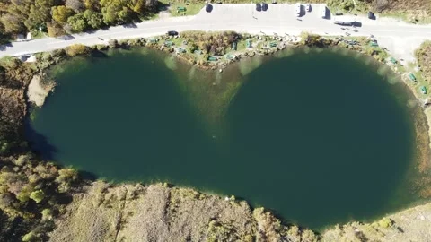 Top-down aerial drone descent over alpine lake in Gonachkhir gorge Stock Footage 337528557