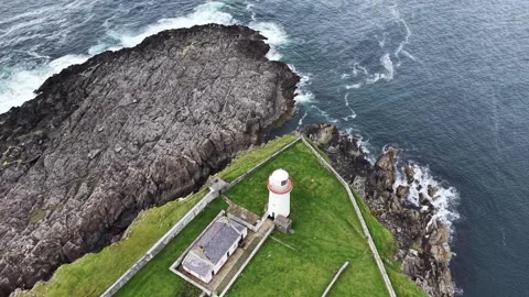 Top-down aerial drone footage slowly orbiting around Ballyglass Lighthouse Stock Footage 342736224