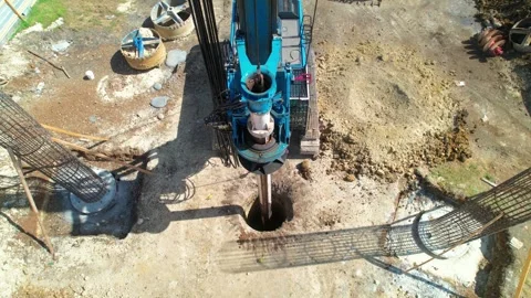 Top Down Aerial Drone Pull Back from Piling Rig Drilling Construction Site Stock Footage 342057435