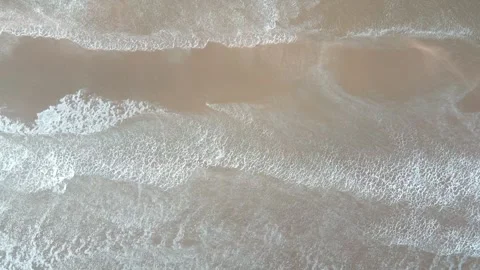 Top down aerial drone scene of waves crashing on IJmuiden beach on a windy .. 스톡 동영상 244410882