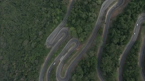 Top Down Aerial Drone Shot of Winding Highway Road on a Forest Mountain Pass wit Stock Footage 213939549