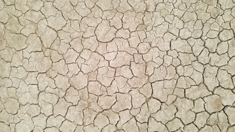 Top down aerial drone shot of desertic dry cracked mud ground soil farmland Stock Footage 237732631